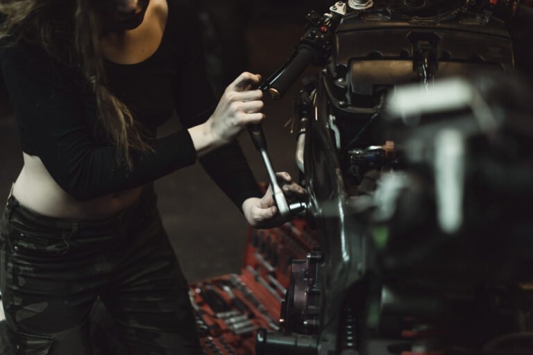 beautiful girl with long hair garage repairing motorcycle